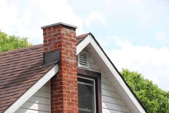 Brick chimney on residential home roof