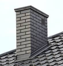 Gray brick chimney on tiled roof