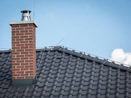 Brick chimney on tiled residential roof