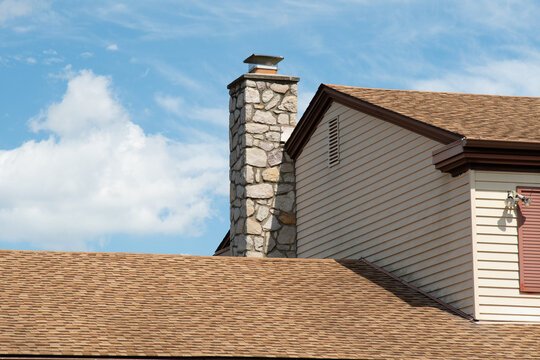 Stone chimney on a residential roof