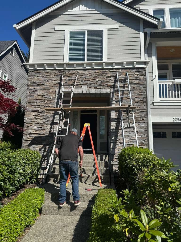 Stone veneer chimney repair on home exterior