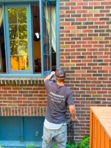 Technician inspecting brick exterior wall